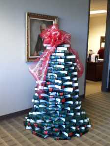 Tall green Christmas tree build of law books.