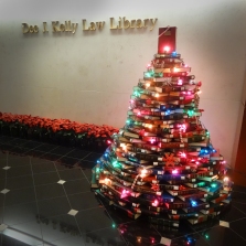 Tall, colorful Christmas tree build of law books.